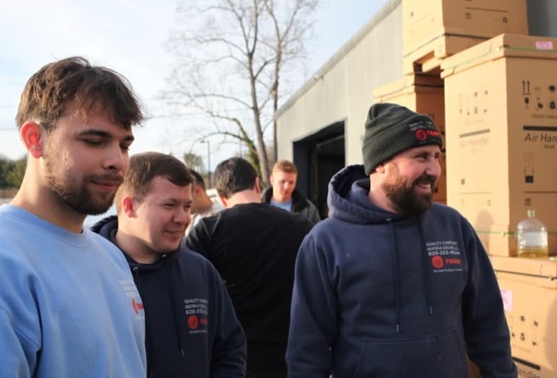 Quality Comfort crew members outside by equipment