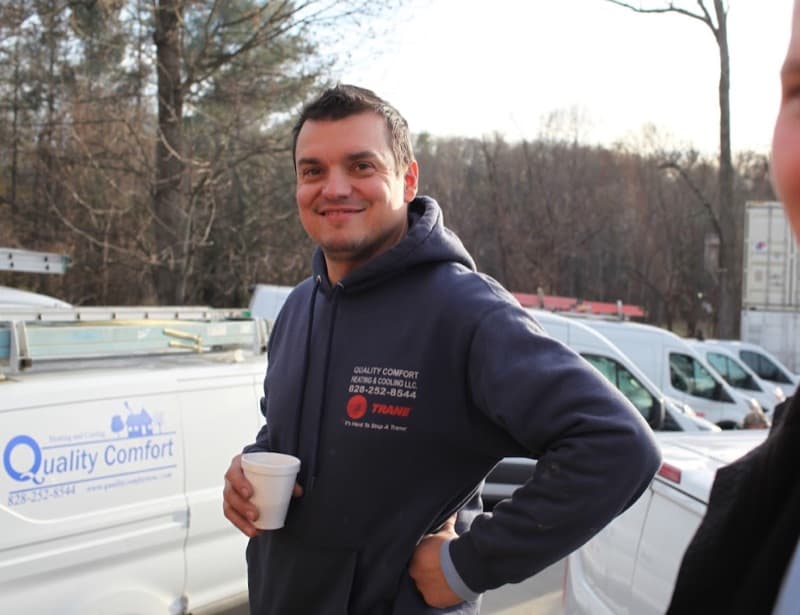 Quality Comfort technician with coffee by service vans