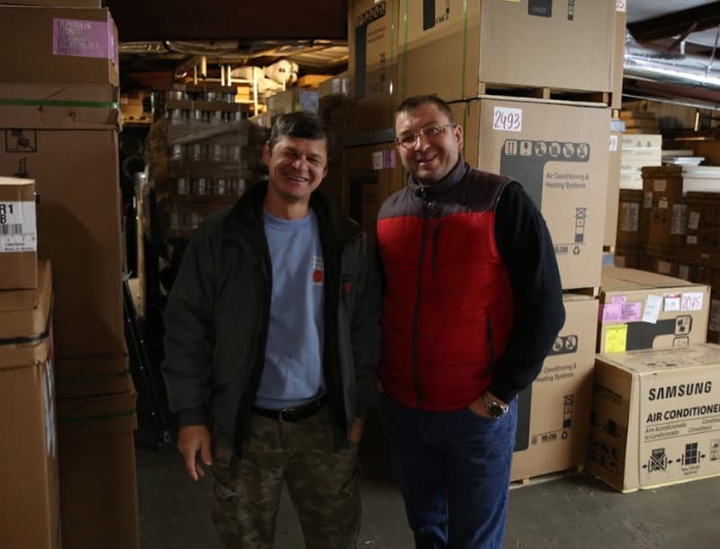 Quality Comfort team members smiling in warehouse